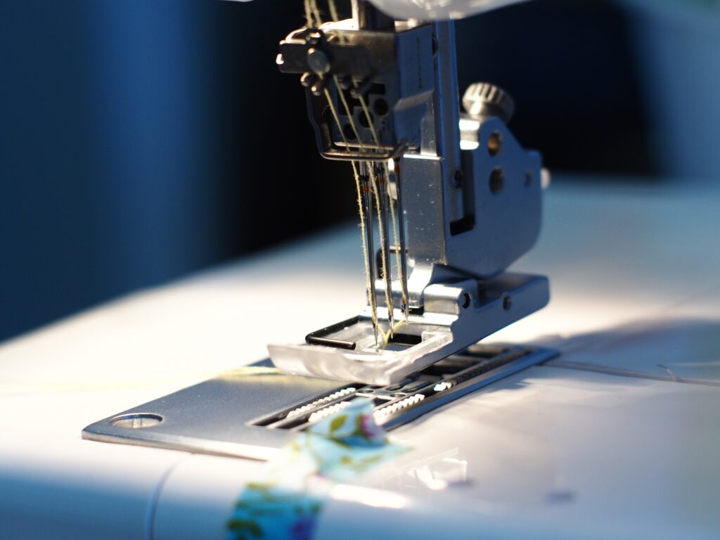Closeup shot of a tailor's electronic machine sewing clothes
